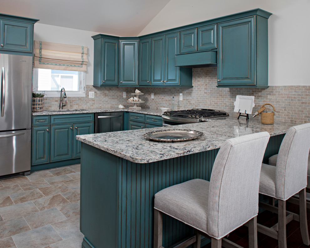 Inspiration for a mid-sized transitional u-shaped ceramic tile and multicolored floor open concept kitchen remodel in New York with an undermount sink, raised-panel cabinets, green cabinets, laminate countertops, beige backsplash, ceramic backsplash, stainless steel appliances and a peninsula