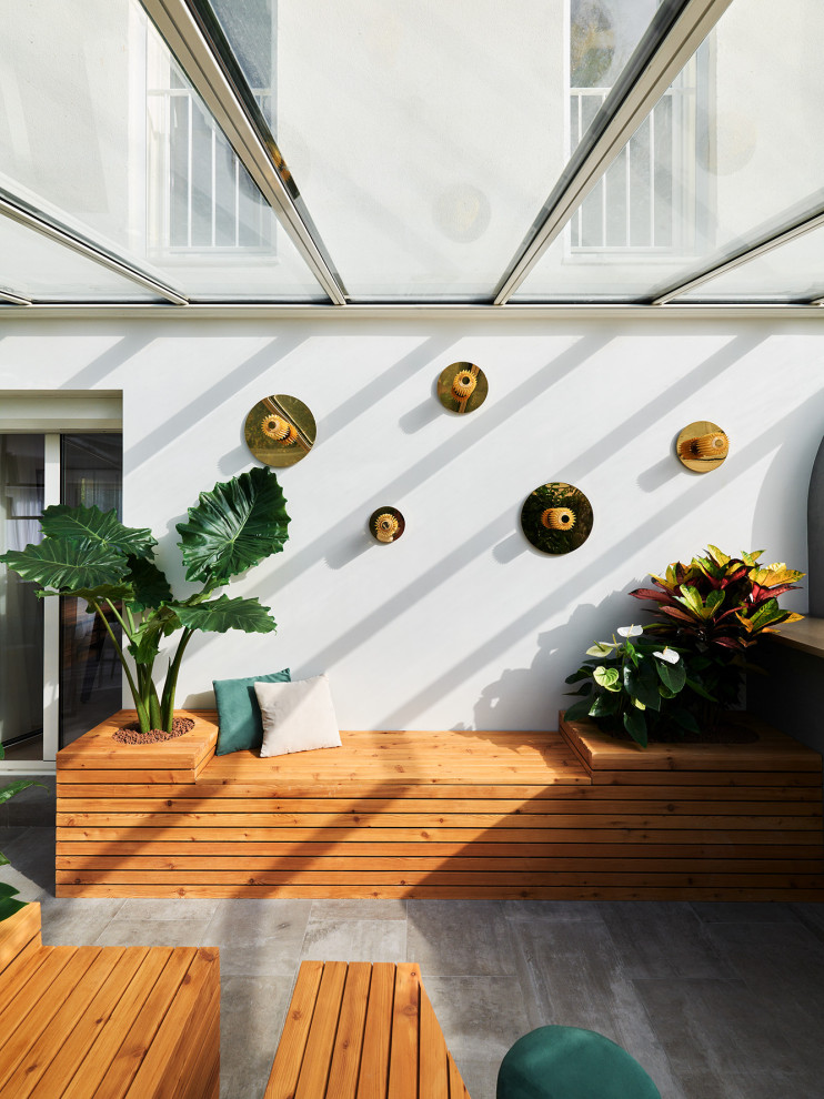 Idee per una grande veranda minimal con parquet chiaro, camino classico, cornice del camino piastrellata, soffitto classico e pavimento beige