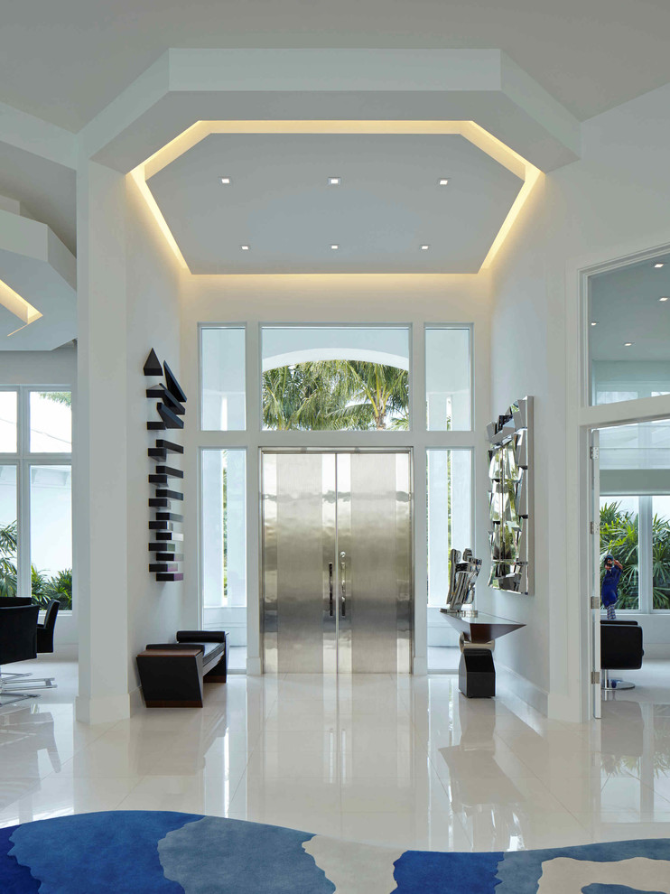 Inspiration for a contemporary entryway in Miami with white walls, a double front door, a metal front door and white floor.