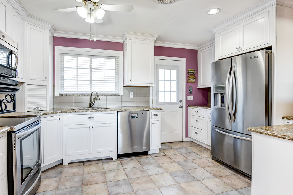 Inspiration for a mid-sized timeless u-shaped ceramic tile eat-in kitchen remodel with an undermount sink, recessed-panel cabinets, white cabinets, granite countertops, beige backsplash, ceramic backsplash, stainless steel appliances and no island