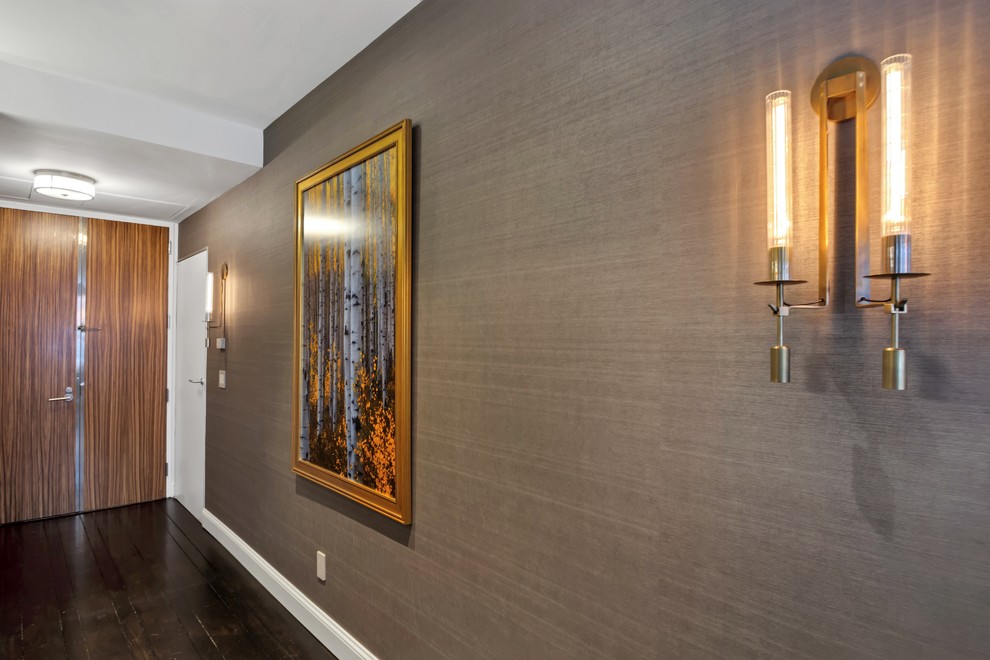 Design ideas for a large transitional hallway in New York with brown walls, dark hardwood floors and brown floor.
