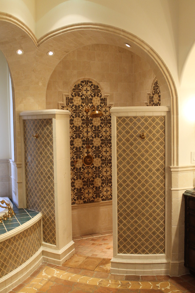 Design ideas for a large mediterranean master bathroom in San Diego with dark wood cabinets, a drop-in tub, an open shower, cement tile, beige walls and terra-cotta floors.