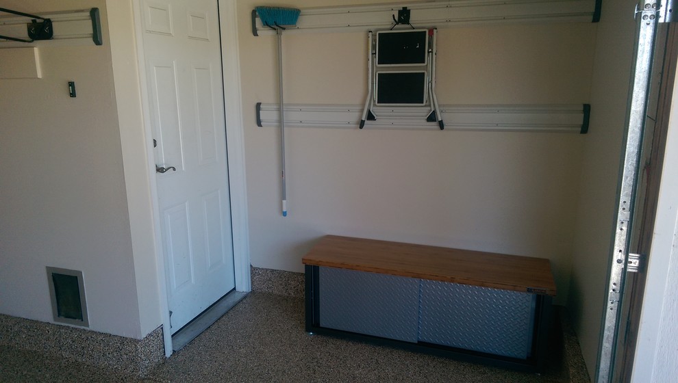 Example of a mid-sized transitional attached two-car garage workshop design in Denver