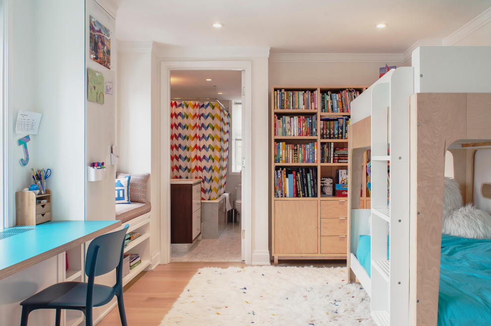New York City Combination-Renovatin - A colorful, fun kid's bedroom.  A gorgeous fabric surface mounted light sets the tone.  Custom built blue laminate work surface, bookshelves and a window seat.  Blue accented window treatments.  A colorful area rug with a rainbow of accents.  Simple clean design.  A column with a glass magnetic board is the final touch.