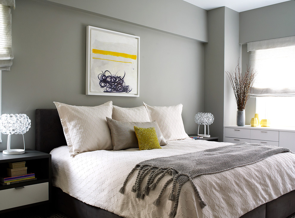 Transitional bedroom in New York with grey walls.