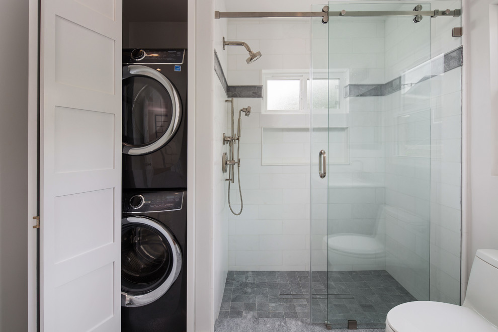 Inspiration for a mid-sized transitional 3/4 bathroom in Los Angeles with furniture-like cabinets, black cabinets, an alcove shower, a one-piece toilet, white tile, marble, grey walls, marble floors, an undermount sink, marble benchtops, grey floor, a sliding shower screen and white benchtops.