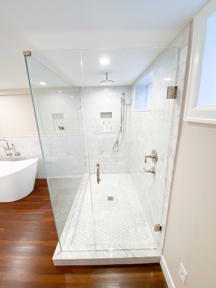 Design ideas for a large arts and crafts master bathroom in Seattle with shaker cabinets, white cabinets, a freestanding tub, an open shower, a two-piece toilet, white tile, marble, beige walls, vinyl floors, an undermount sink, engineered quartz benchtops, brown floor, a hinged shower door, pink benchtops, a double vanity and a built-in vanity.