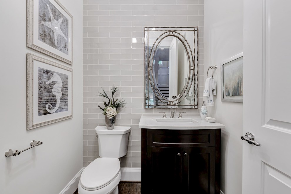 Mid-sized transitional 3/4 bathroom in DC Metro with shaker cabinets, dark wood cabinets, a two-piece toilet, white tile, subway tile, white walls, an integrated sink and plywood floors.