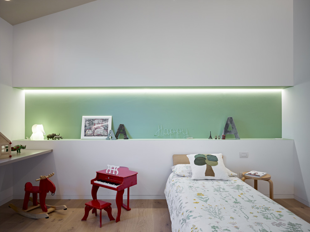 Example of a danish medium tone wood floor and beige floor kids' bedroom design in Other with white walls