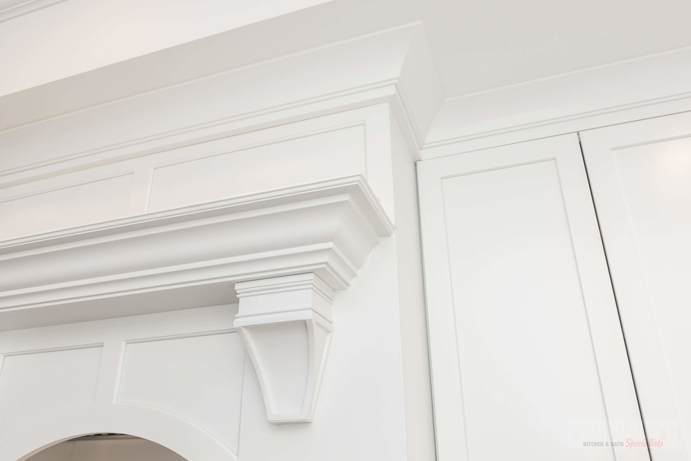 Inspiration for a large u-shaped plywood floor eat-in kitchen remodel in New York with a farmhouse sink, recessed-panel cabinets, white cabinets, quartzite countertops, white backsplash, ceramic backsplash, stainless steel appliances and an island