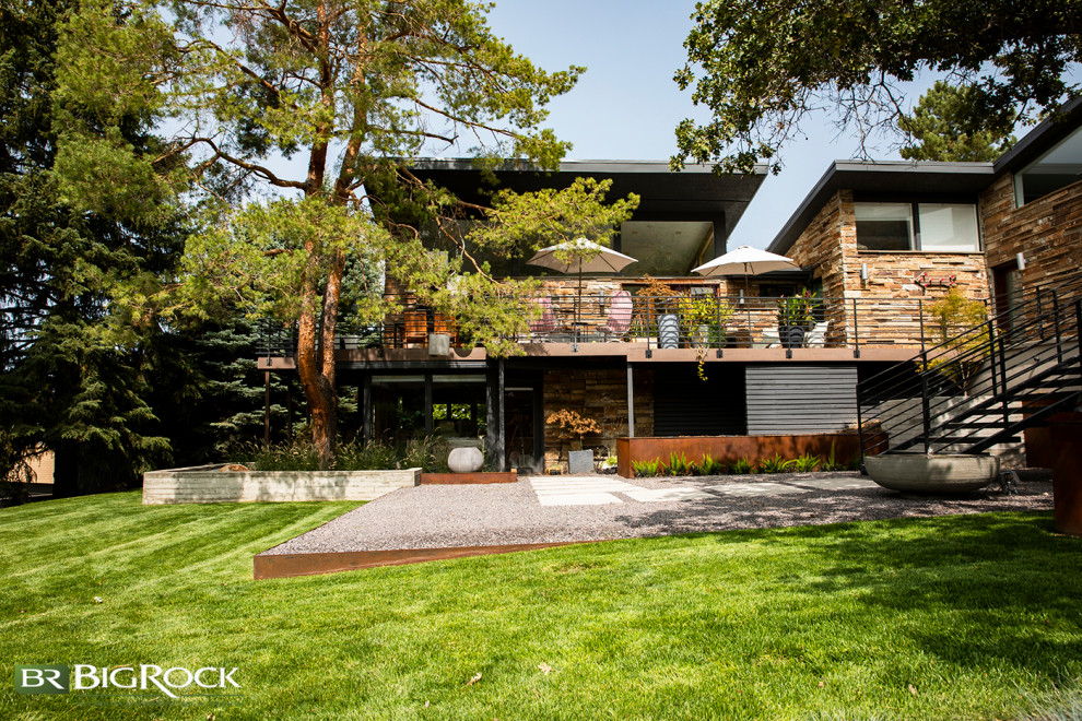 Large contemporary front xeriscape garden in Salt Lake City with a waterfall and concrete paving.