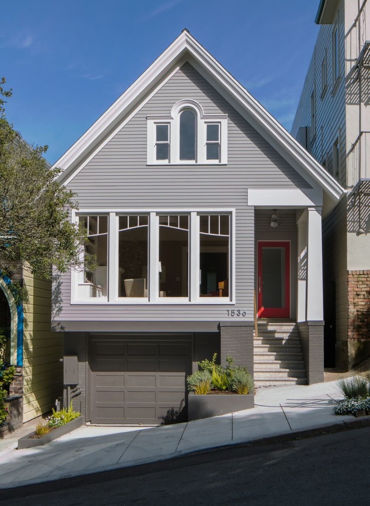 This is an example of a mid-sized contemporary three-storey grey exterior in San Francisco with a gable roof.