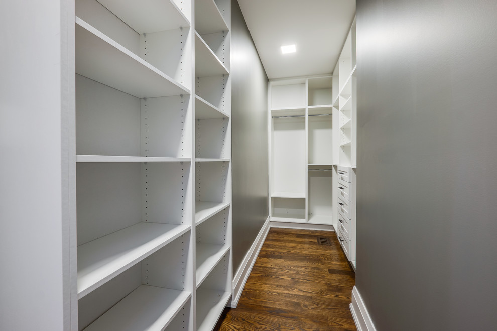 Design ideas for a large modern women's walk-in wardrobe in Toronto with open cabinets, white cabinets and medium hardwood floors.