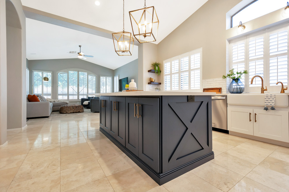 Open concept kitchen - large transitional u-shaped open concept kitchen idea in Phoenix with a farmhouse sink, shaker cabinets, white cabinets, quartz countertops, white backsplash, subway tile backsplash, stainless steel appliances, an island and white countertops