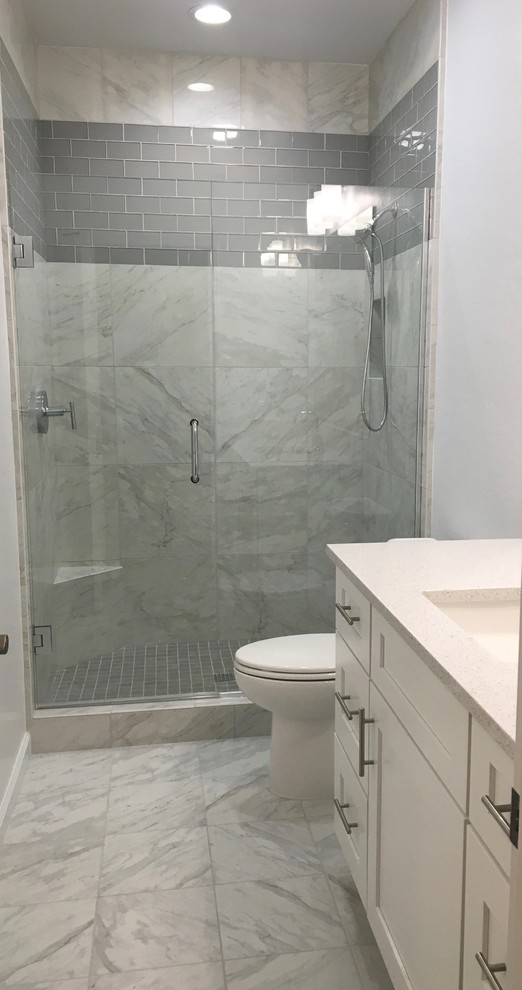 Inspiration for a mid-sized transitional white tile and ceramic tile ceramic tile bathroom remodel in Phoenix with recessed-panel cabinets, white cabinets, a one-piece toilet, white walls, an undermount sink and quartz countertops