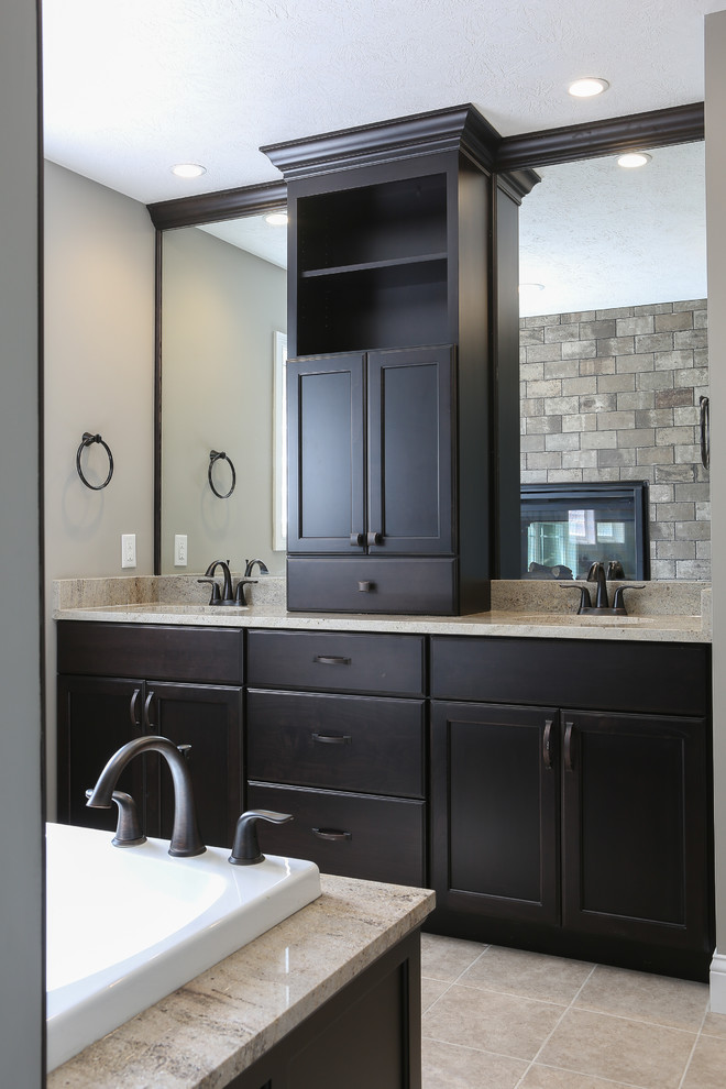Large transitional master bathroom in Other with recessed-panel cabinets, dark wood cabinets, porcelain floors, granite benchtops, beige floor, an undermount tub, beige tile, gray tile, multi-coloured tile, cement tile, grey walls, an undermount sink and beige benchtops.