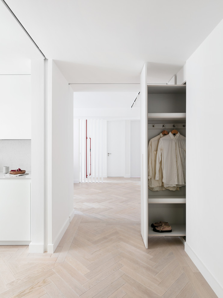 Medium sized contemporary foyer in London with white walls, light hardwood flooring, a single front door, a white front door and beige floors.