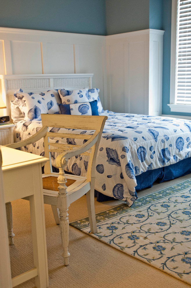 This is an example of a mid-sized beach style bedroom in Other with blue walls and carpet.