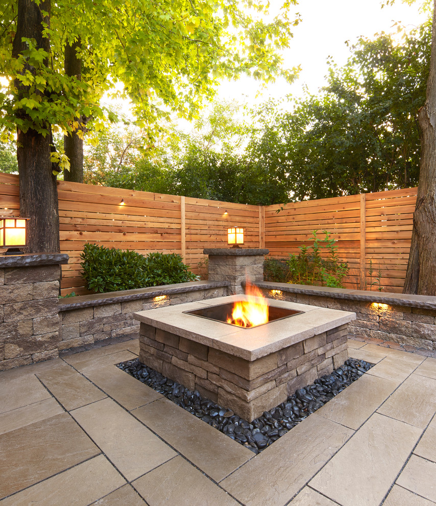 Inspiration for a traditional backyard patio in New York with a fire feature, natural stone pavers and no cover.