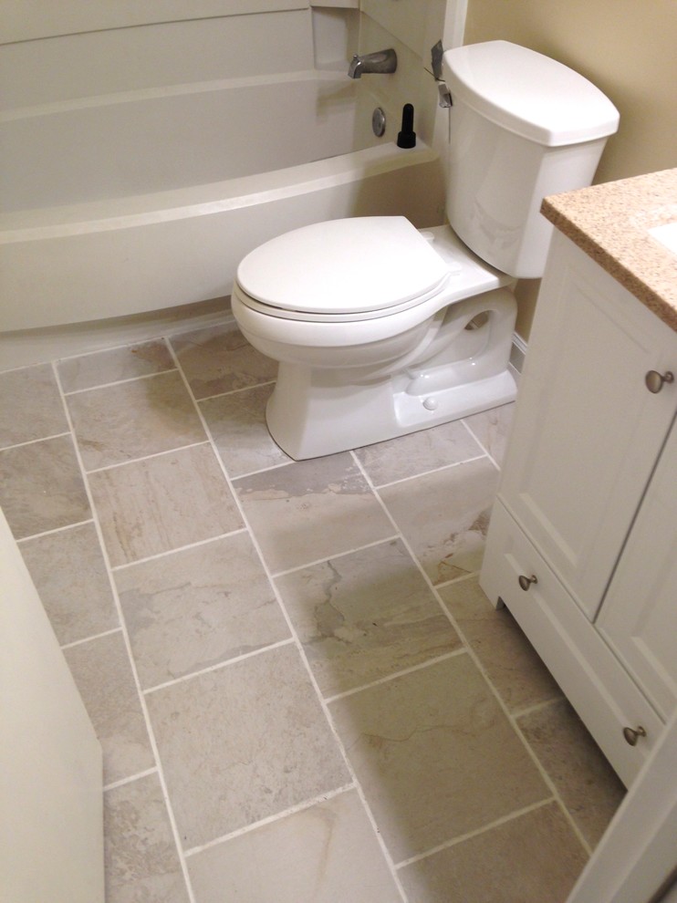 Small transitional 3/4 white tile and porcelain tile porcelain tile home design photo with an integrated sink, flat-panel cabinets, white cabinets, solid surface countertops, a one-piece toilet and beige walls