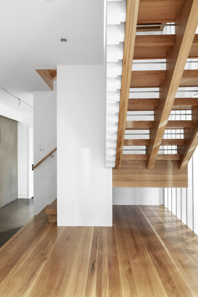 Design ideas for a medium sized scandinavian wood l-shaped wood railing staircase in Indianapolis with open risers.