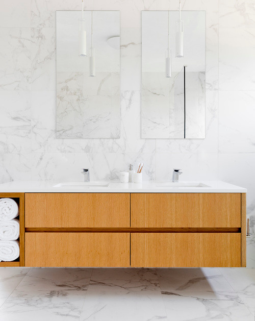 Large modern master bathroom in New York with flat-panel cabinets, light wood cabinets, a drop-in tub, an open shower, a wall-mount toilet, multi-coloured tile, marble, multi-coloured walls, marble floors, a console sink, marble benchtops, multi-coloured floor and an open shower.