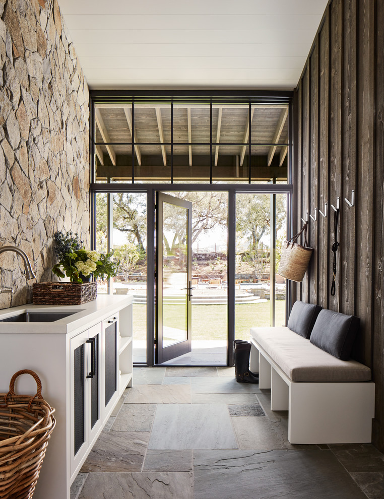 Country entryway in San Francisco with a single front door, a glass front door and grey floor.