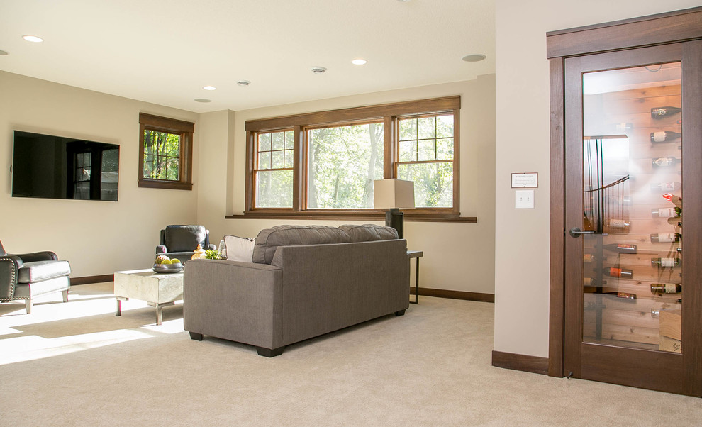 This is an example of a transitional walk-out basement in Minneapolis with grey walls, carpet and no fireplace.