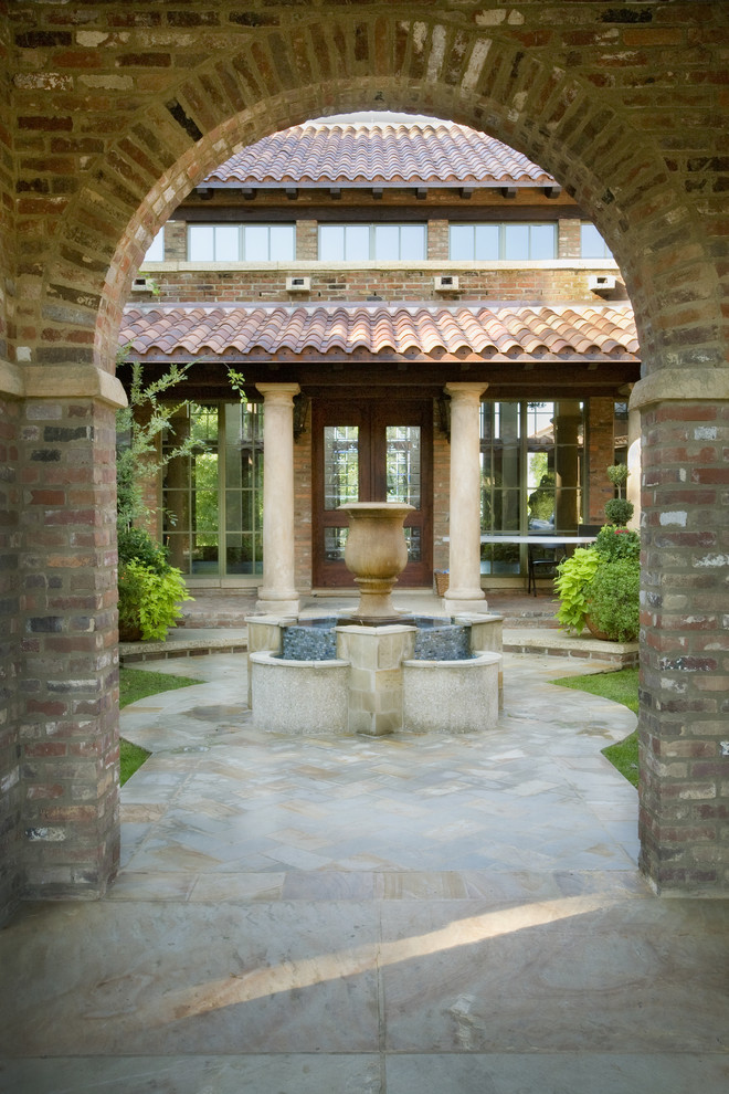 Design ideas for a mediterranean courtyard patio in Austin with a water feature.