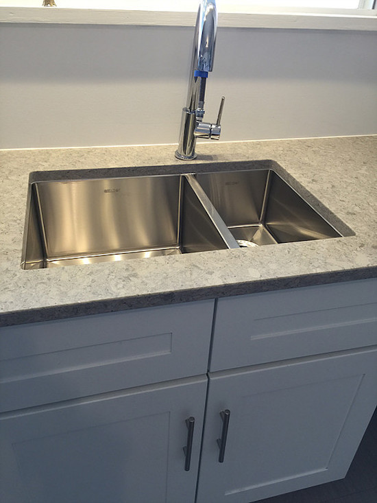 Example of a transitional kitchen design in Phoenix with a double-bowl sink, shaker cabinets, white cabinets and granite countertops