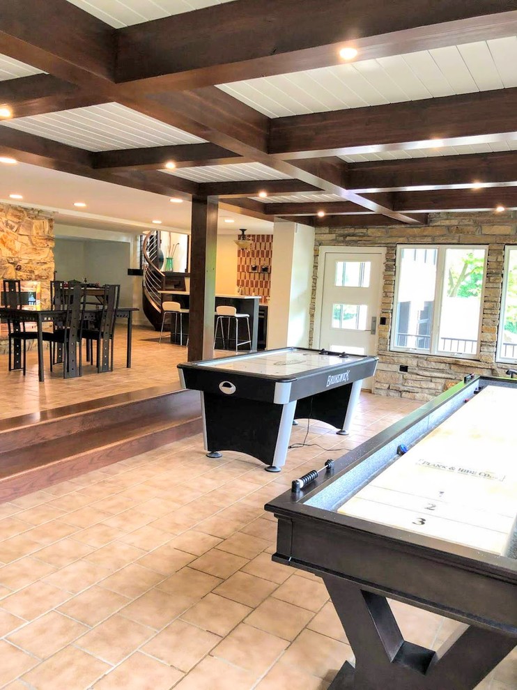 Basement - large contemporary walk-out ceramic tile and beige floor basement idea in Chicago with white walls, a two-sided fireplace and a stone fireplace