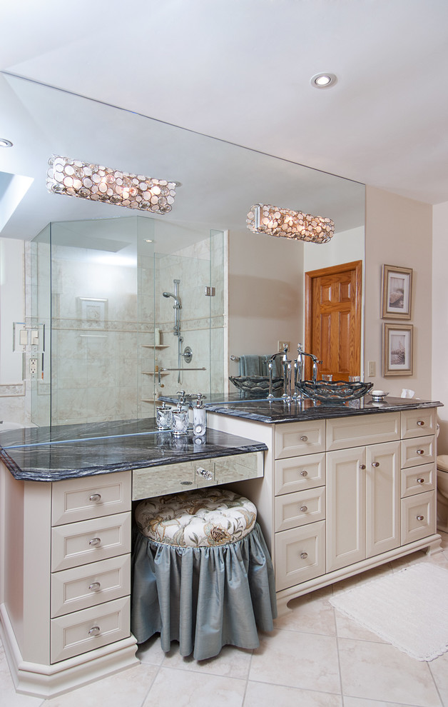 Large traditional master bathroom in Toronto with a vessel sink, recessed-panel cabinets, an alcove shower, white cabinets, a corner tub, a one-piece toilet, beige walls, ceramic floors, limestone benchtops, beige floor and a hinged shower door.