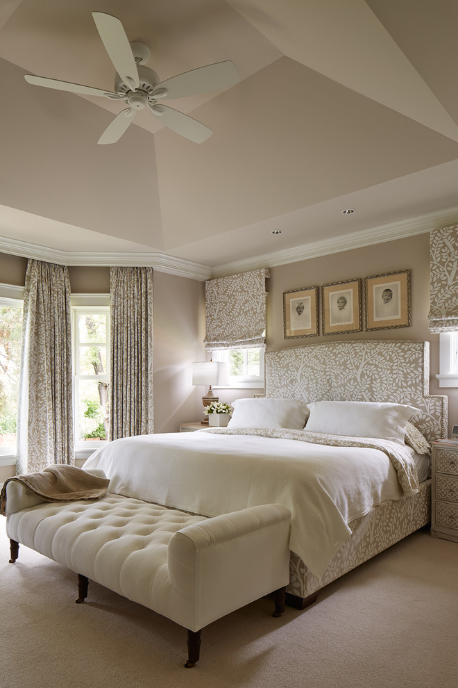 This is an example of a large transitional master bedroom in Minneapolis with beige walls, carpet and no fireplace.