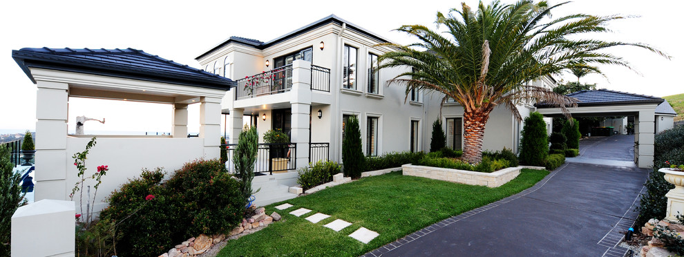 Inspiration for a large modern two-storey beige house exterior in Sydney with a tile roof and a hip roof.