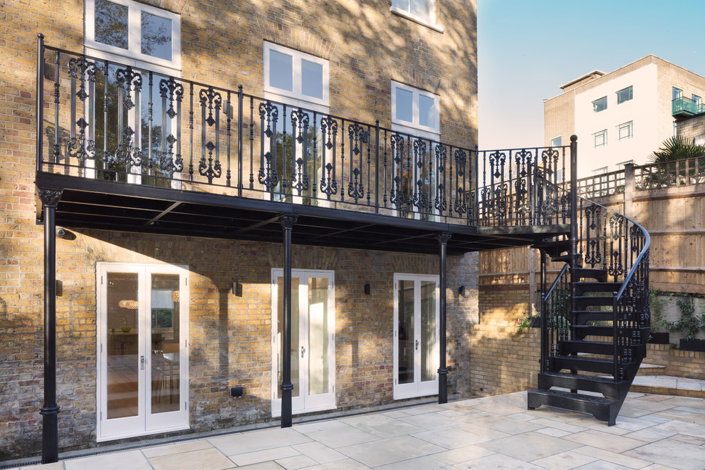 Inspiration for a mid-sized traditional balcony in London with metal railing.