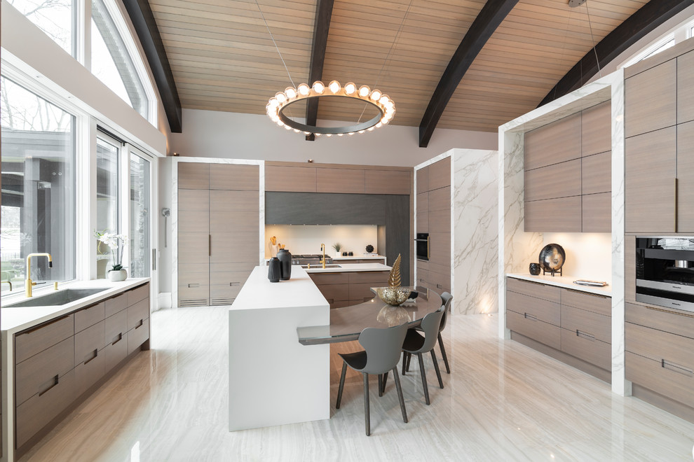 Photo of a contemporary kitchen in Toronto with an undermount sink, flat-panel cabinets, brown cabinets, white splashback, with island, beige floor and white benchtop.