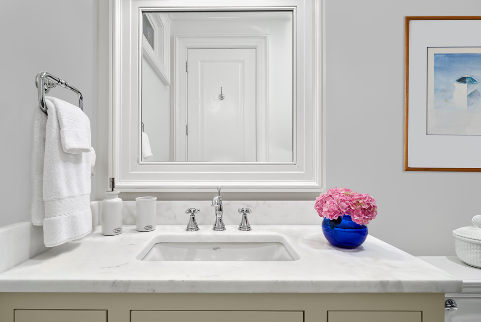 This is an example of a mid-sized transitional 3/4 bathroom in Charleston with shaker cabinets, grey walls, an undermount sink, marble benchtops, white tile, subway tile, a one-piece toilet and grey cabinets.