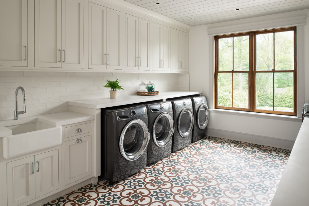 Inspiration for an expansive country laundry room in New York with a farmhouse sink, beaded inset cabinets, white cabinets, quartz benchtops, white splashback, subway tile splashback, white walls, ceramic floors, a side-by-side washer and dryer, blue floor, white benchtop, timber and planked wall panelling.
