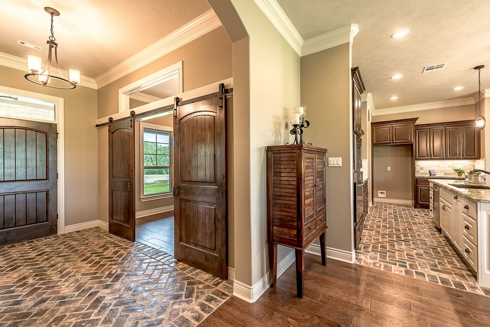 Example of a mid-sized mountain style medium tone wood floor and brown floor foyer design in Austin with beige walls and a medium wood front door