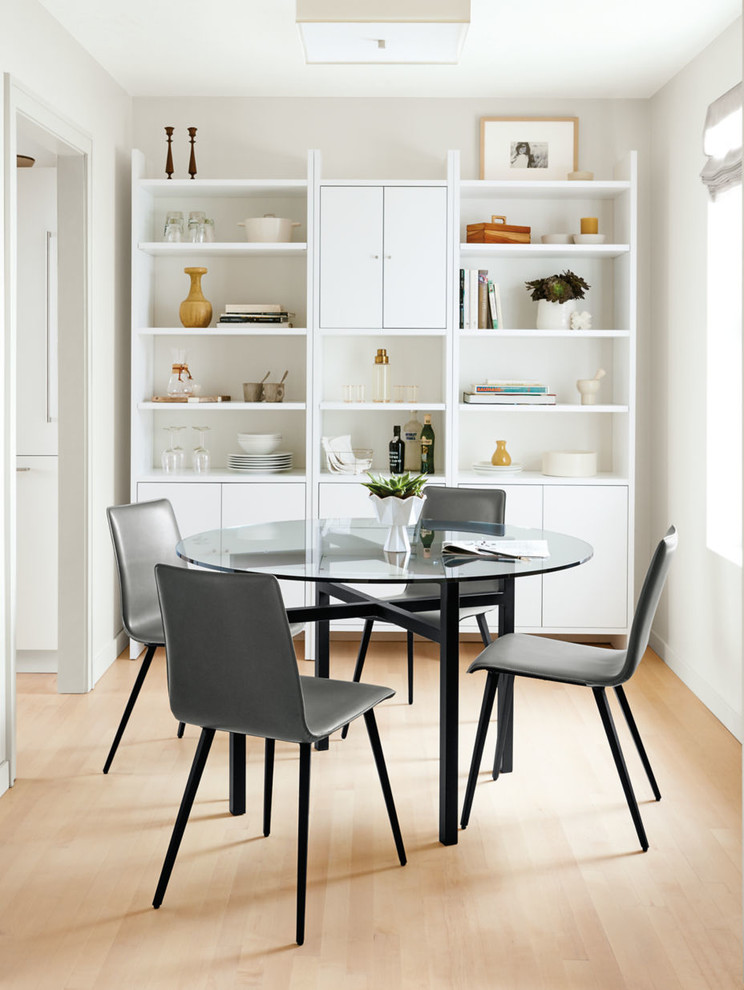 Photo of a contemporary separate dining room in Minneapolis with white walls and light hardwood floors.