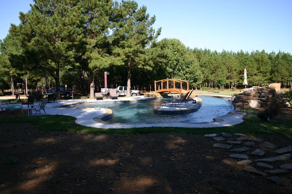 Example of a transitional backyard custom-shaped pool fountain design