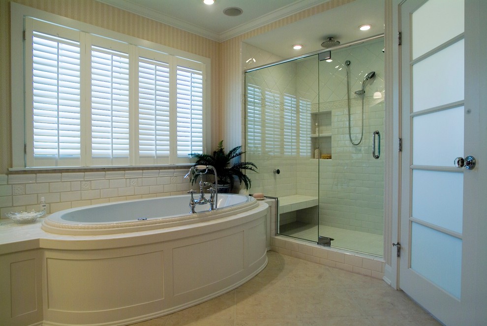 Design ideas for a large traditional master bathroom in Grand Rapids with white cabinets, a drop-in tub, an alcove shower, a one-piece toilet, beige tile, subway tile, pink walls and slate floors.