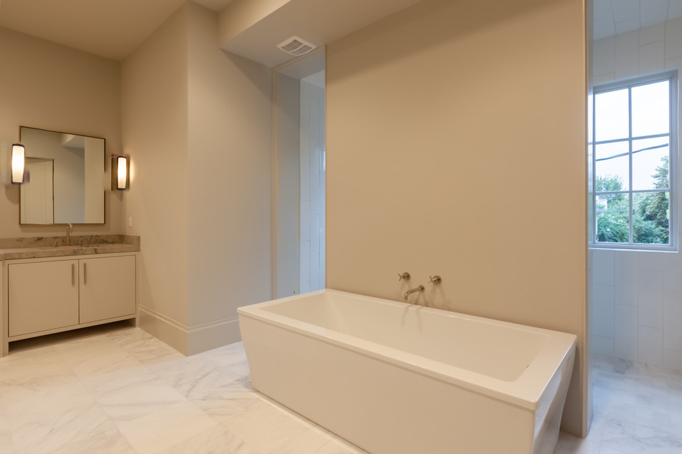 Transitional master white tile freestanding bathtub photo in Houston with beige walls