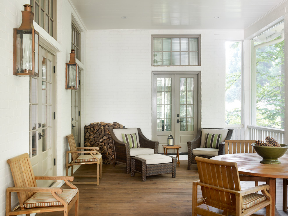 This is an example of a traditional porch design in Atlanta with a roof extension.