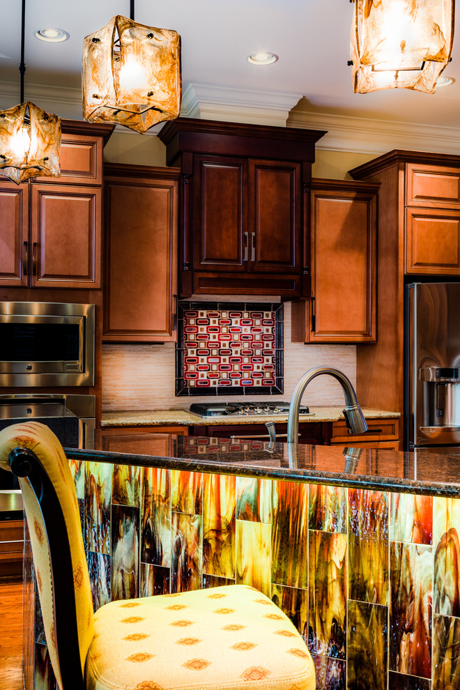 Example of a large eclectic medium tone wood floor kitchen design with raised-panel cabinets, dark wood cabinets, granite countertops, white backsplash, stainless steel appliances and an island