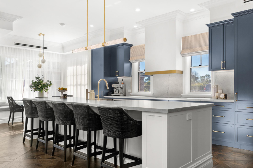 Large transitional galley eat-in kitchen in Sydney with an undermount sink, shaker cabinets, marble benchtops, grey splashback, marble splashback, stainless steel appliances, dark hardwood floors, with island, brown floor and grey benchtop.
