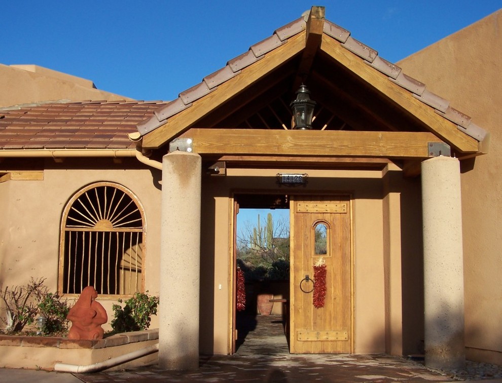 Photo of a large one-storey adobe beige exterior in Phoenix.