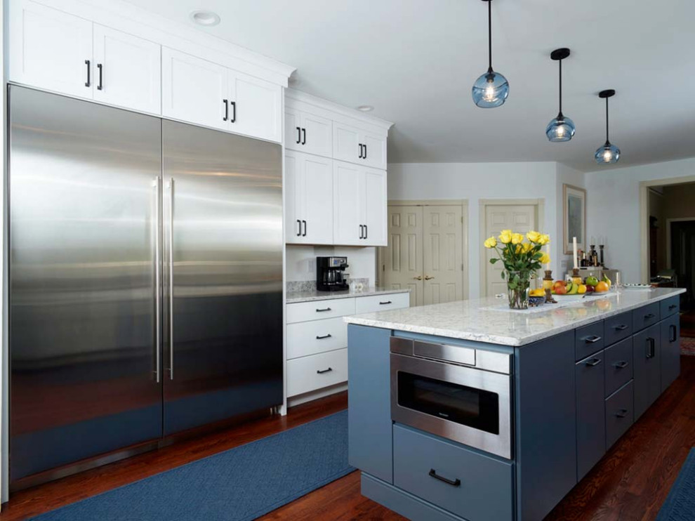 Design ideas for an expansive transitional galley eat-in kitchen in Philadelphia with an undermount sink, flat-panel cabinets, blue cabinets, quartzite benchtops, white splashback, stainless steel appliances, with island, brown floor and white benchtop.