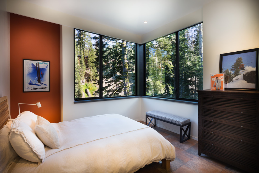 This is an example of a contemporary guest bedroom in San Francisco with orange walls and ceramic floors.