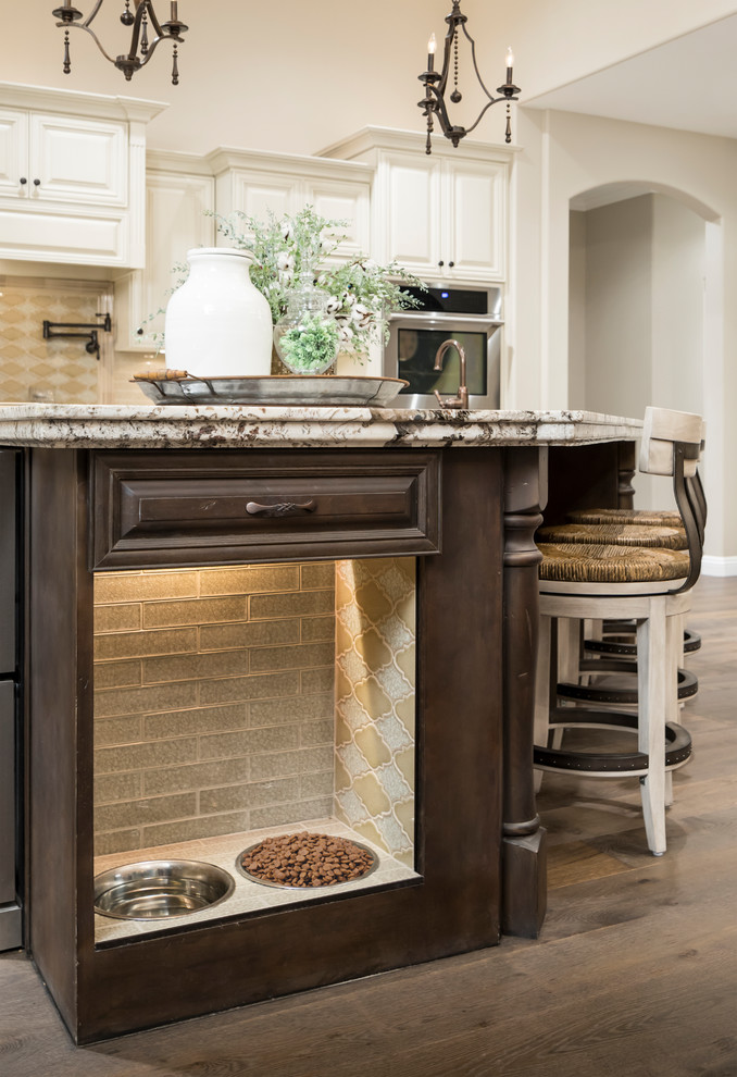Eat-in kitchen - large transitional l-shaped medium tone wood floor and brown floor eat-in kitchen idea in Phoenix with raised-panel cabinets, beige backsplash, glass tile backsplash, stainless steel appliances, an island, an undermount sink, beige cabinets and quartz countertops